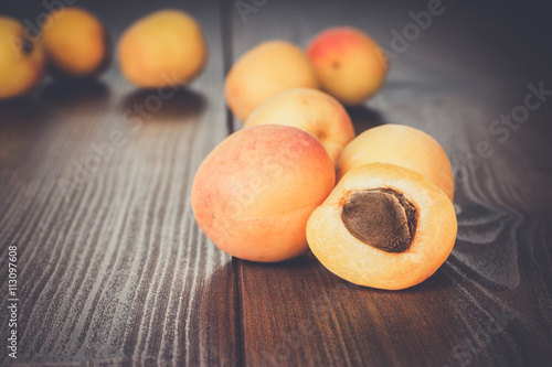 some fresh apricots over brown wooden background