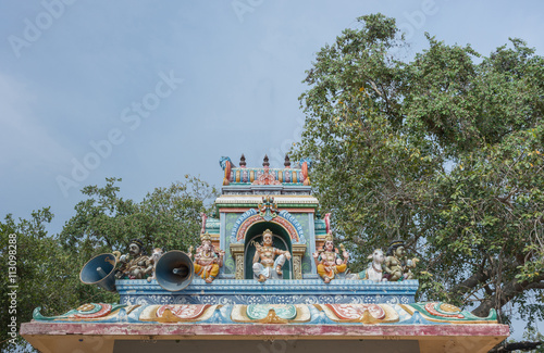 Chettinad, India - October 17, 2013: Kothamangalam Ayyanar horse shrine. On top of small shrine, sits Lord Shiva and his two sons, Ganesha and Murugan. Ayyanar figures on the corners.