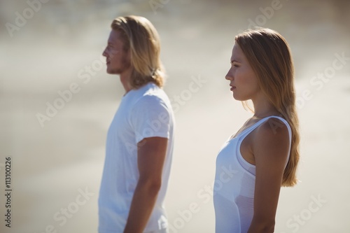 Man and woman standing on beach