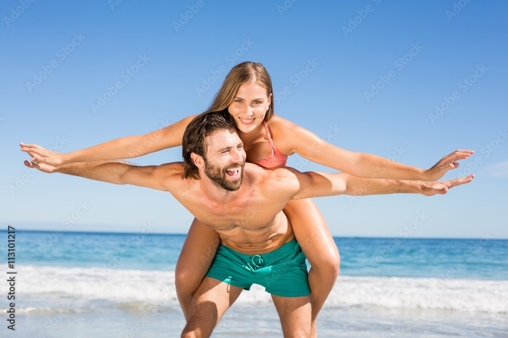 Man giving piggy back ride to woman Man giving piggy back ride to woman