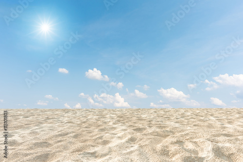 Sand dunes and blue sky with sun