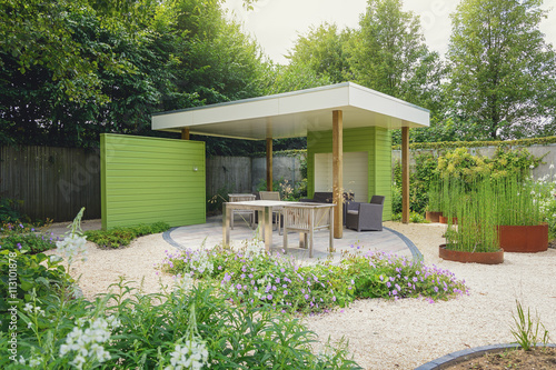 Garden with terrace and overhang, decorated with trendy garden f
