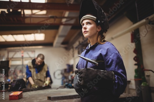Female welder in protective workwear photo