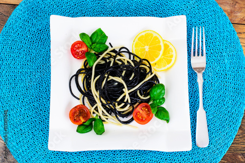 Black Spaghetti with Cuttlefish Ink, Tomato and Basil. Mediterra photo