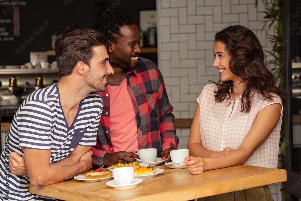 Friends talking together and smiling Friends talking together and smiling