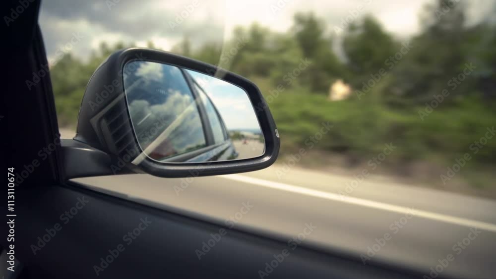 Movement in the car mirror, View of the road Movement in the car mirror, View of the road