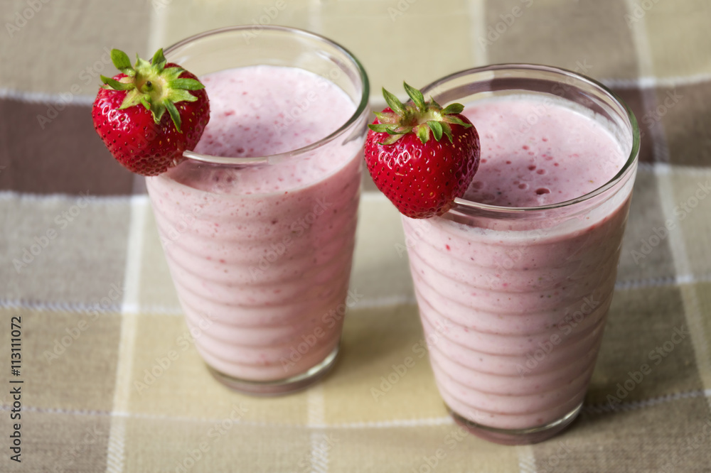 Fresh strawberry smoothie - spring cockail decorated with fresh red strawberries. Sweet spring drink full of vitamin. Fresh strawberry smoothie - spring cockail decorated with fresh red strawberries. Sweet spring drink full of vitamin.