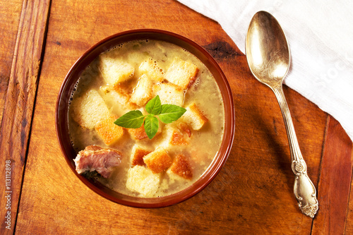 Delicious pea soup with smoked ribs and croutons