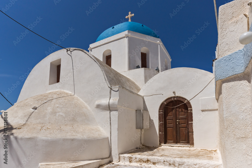 Fototapeta premium White Orthodox church with blue roof in Santorini island, Thira, Cyclades, Greece