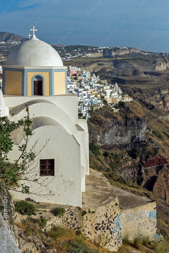 Orthodox church in town of Firostefani and panoramic view of Santorini island, Thira, Cyclades, Greece