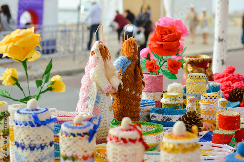 Knitted goods displayed on market stall for sale. © gorosi