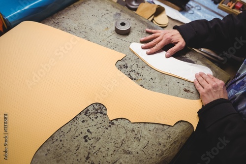 Cobbler measuring the sizing of a shoe