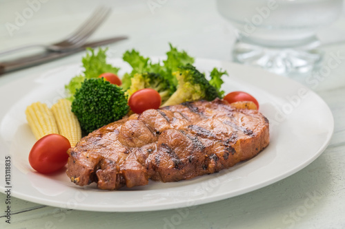Grilled steak and vegetables on plate