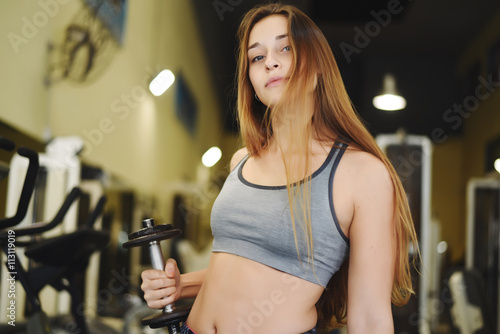 Athlete young woman doing exercise at gym.