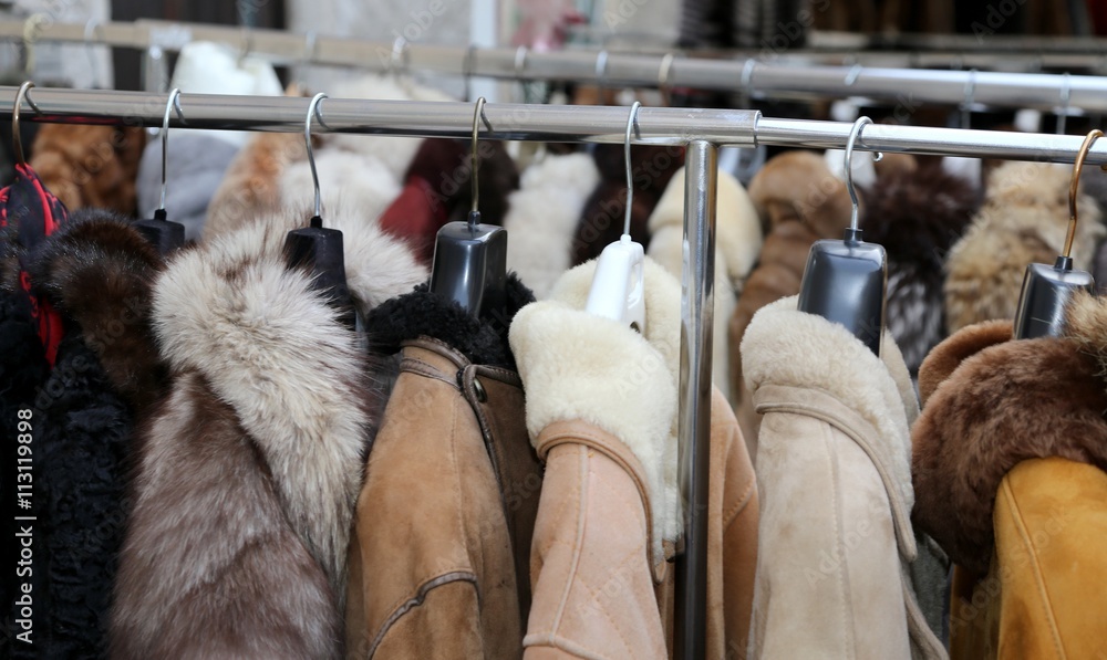 winter jackets fur coat hanging for sale in flea markets