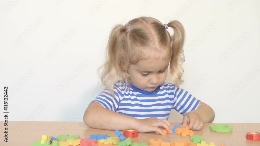 child little girl playing plastic constructor toys at home or kindergarten. child little girl playing plastic constructor toys at home or kindergarten.