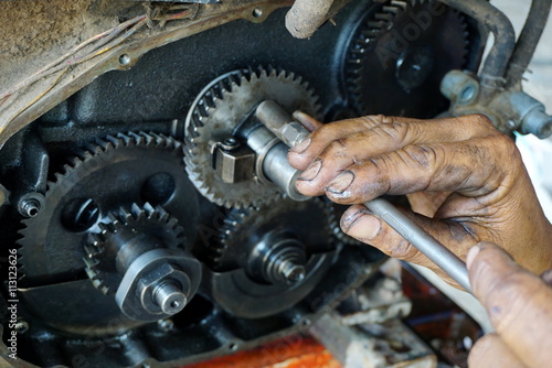 repairman hands fixing on engine at a repair service