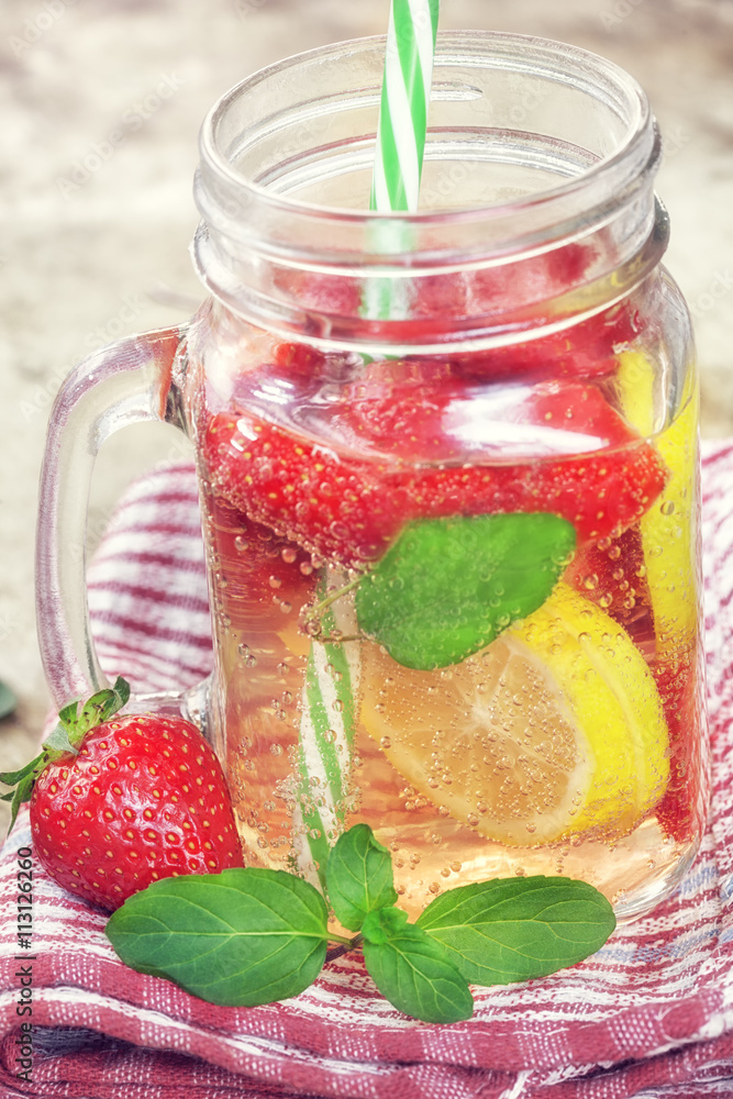 Detox Infused water with lemon, strawberry and mint on wooden background Detox Infused water with lemon, strawberry and mint on wooden background