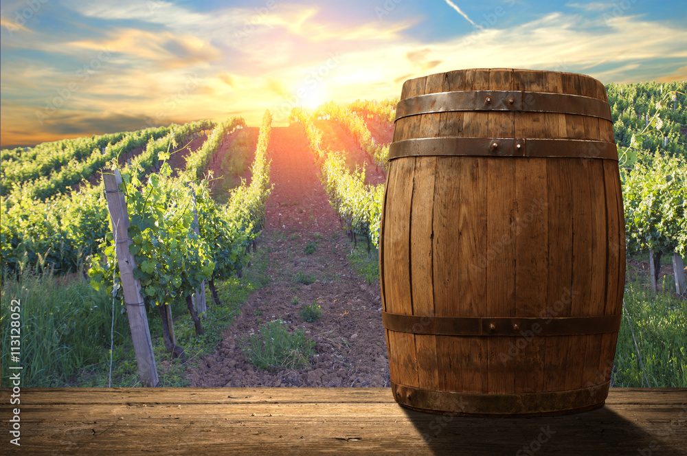 Red wine with barrel on vineyard in green Tuscany, Italy Red wine with barrel on vineyard in green Tuscany, Italy