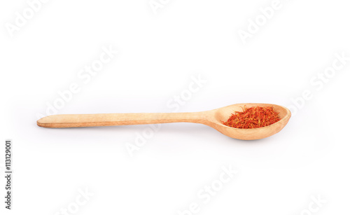 spices in a wooden spoon on a white background