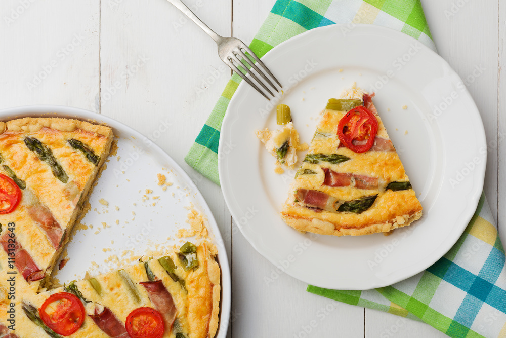 Tart with asparagus and tomatoes on white wooden background. Tart with asparagus and tomatoes on white wooden background.