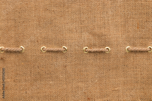 Burlap with one lines of rope and gold rings