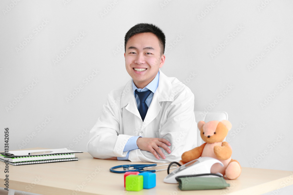 Handsome pediatrician doctor in office Handsome pediatrician doctor in office
