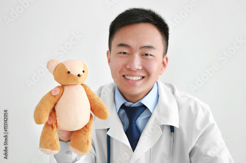 Handsome male doctor holdin...
