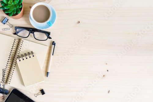 Blank notebook with cup of coffee on desk office