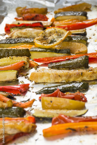 Roasted winter vegetables on aluminium foil on tray,pepper, zucc