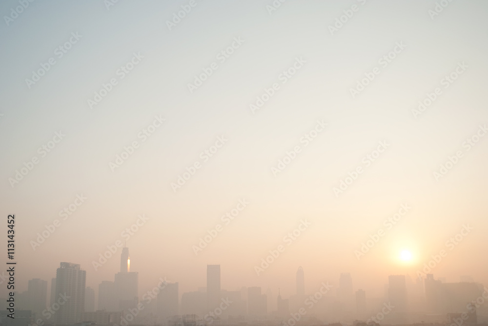 smog cityscape at sunset and blue sky