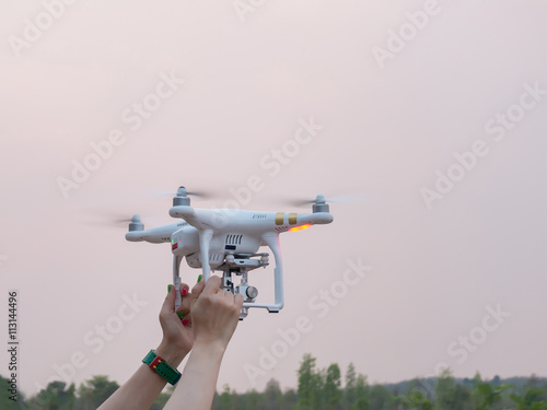 Woman Hand holding Drone at sunset