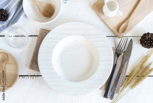 Empty dish with knife and fork on old wooden background