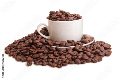 Coffee beans and a white cup on white background