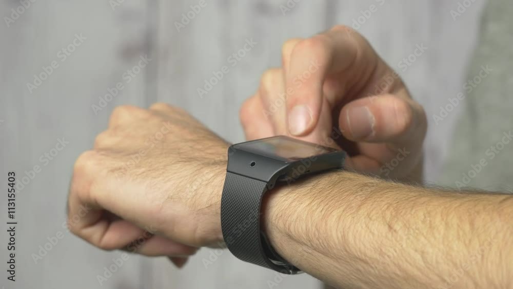Man using his wearable smartwatch computer device. Wearable technology is a growing trend. 