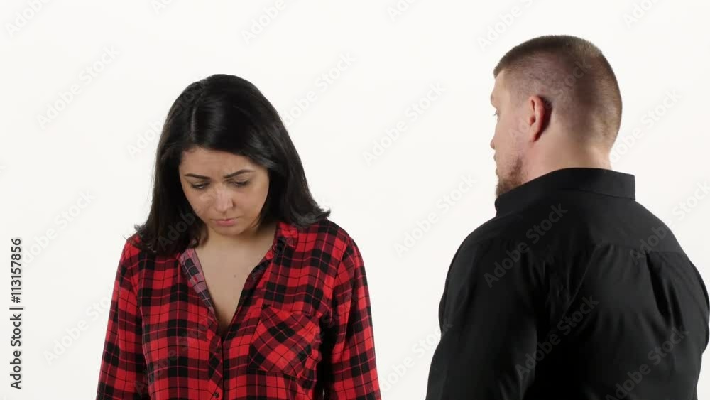 Annoyed man yelling at frightened woman on white background Annoyed man yelling at frightened woman on white background