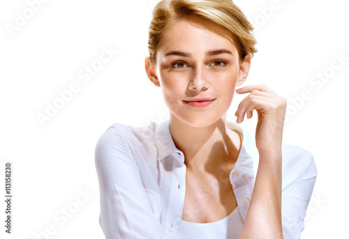 Gorgeous young model. Close up of an attractive girl of European appearance on white background. Youth and skin care concept