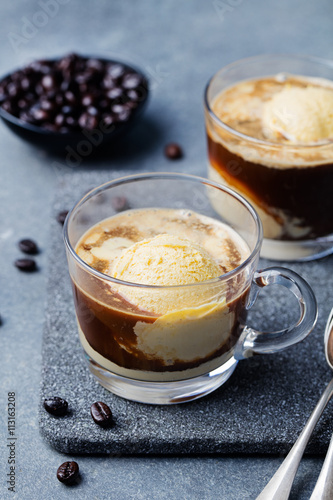 Affogato coffee with ice cream on a glass cup Grey slate background