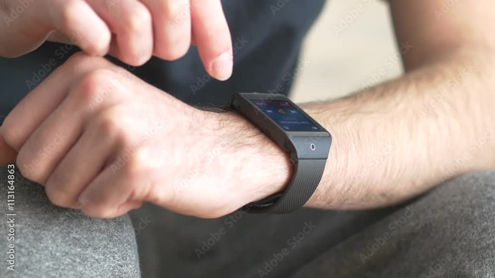 Man using his smartwatch computer to monitor his heart beat. Man using his smartwatch computer to monitor his heart beat.