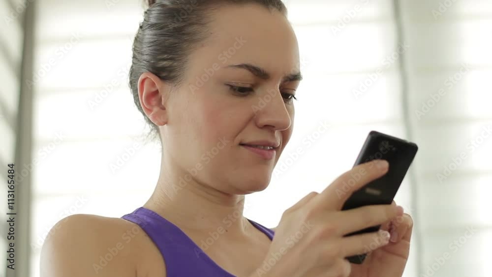 Portrait of woman sending a text message from her cell phone, close up Portrait of woman sending a text message from her cell phone, close up