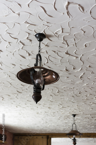 electric lamp on the ceiling with decorative plaster on the ceiling
