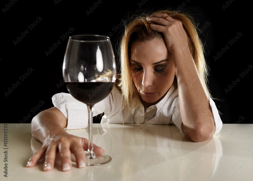 drunk alcoholic blond woman alone in wasted depressed drinking red wine glass suffering hangover drunk alcoholic blond woman alone in wasted depressed drinking red wine glass suffering hangover