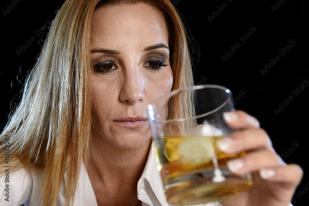 drunk alcoholic woman alone in wasted depressed face holding and looking thoughtful to scotch whiskey glass drunk alcoholic woman alone in wasted depressed face holding and looking thoughtful to scotch whiskey glass