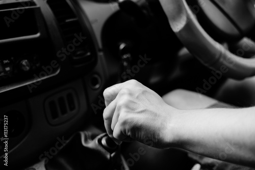 UK right hand drive car. black white photography driver closeup changing gear