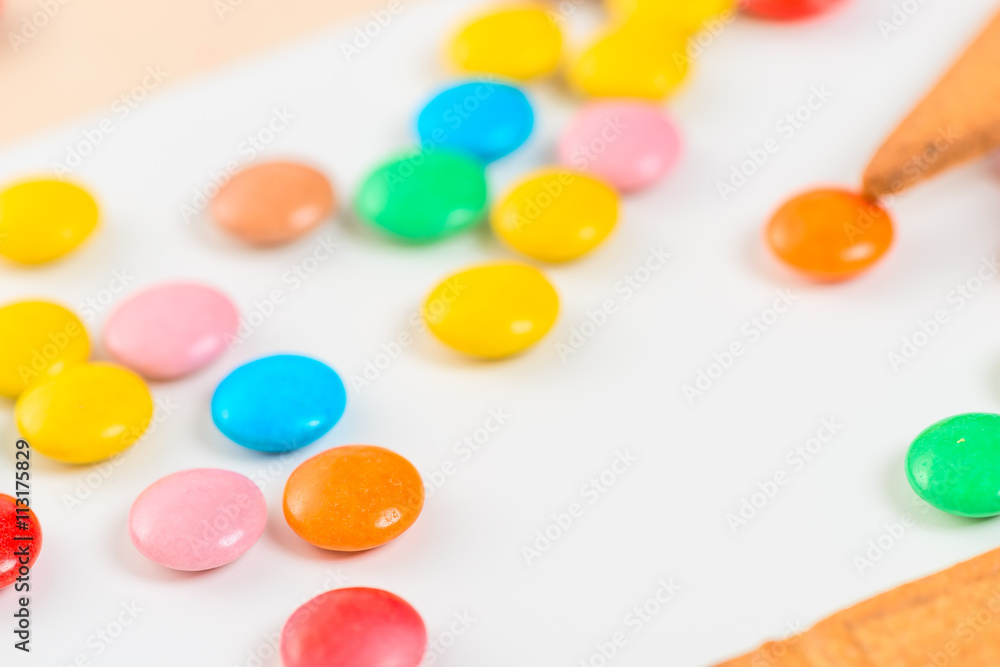 close-up of colorful candies jelly beans on white table close-up of colorful candies jelly beans on white table