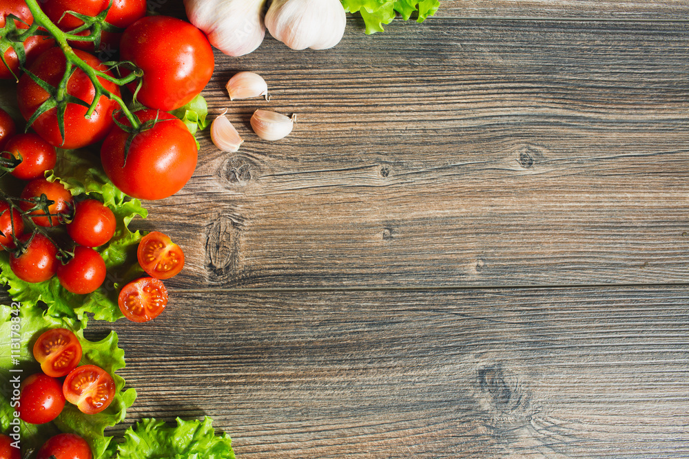 Fresh tomatoes with salad leaves on the table. Background. Fresh tomatoes with salad leaves on the table. Background.