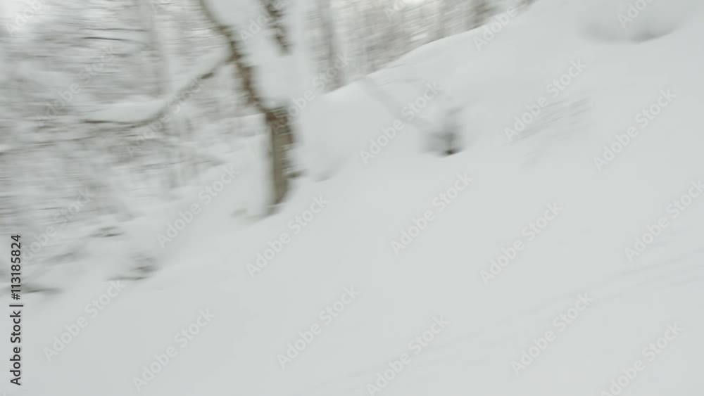 Snowboarder Big Jump Grabbing His Snowboard Indy Air into a Powder Snow Field at a Backcountry Snowboarding Spot Snowboarder Big Jump Grabbing His Snowboard Indy Air into a Powder Snow Field at a Backcountry Snowboarding Spot