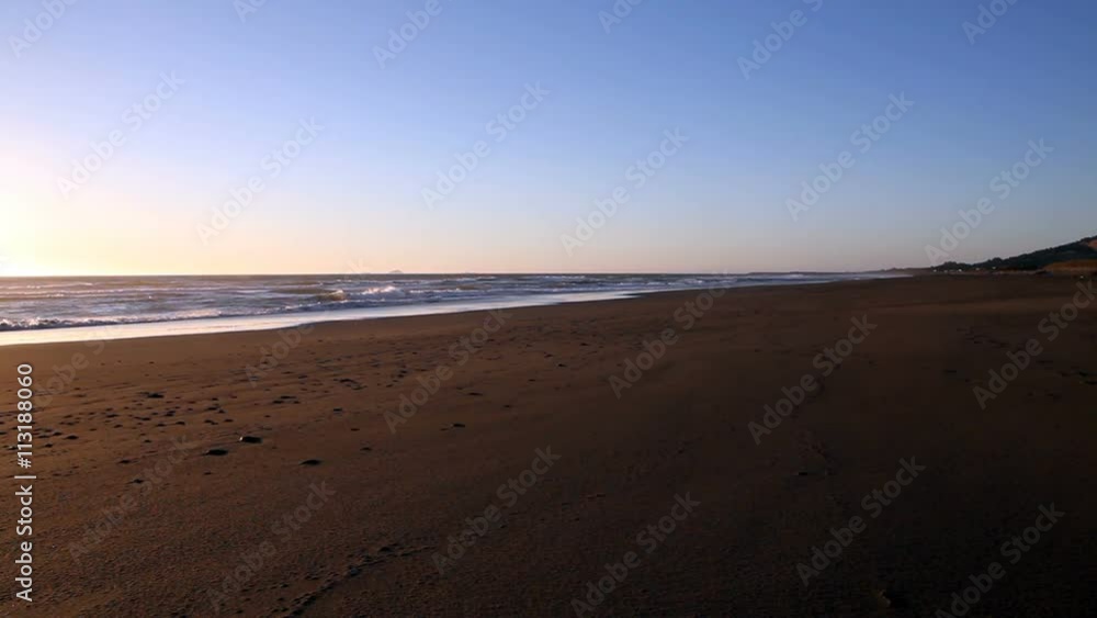 Empty Red Sand Beach With Waves And Blue Sky
Empty Red Sand Beach With Waves And Blue Sky