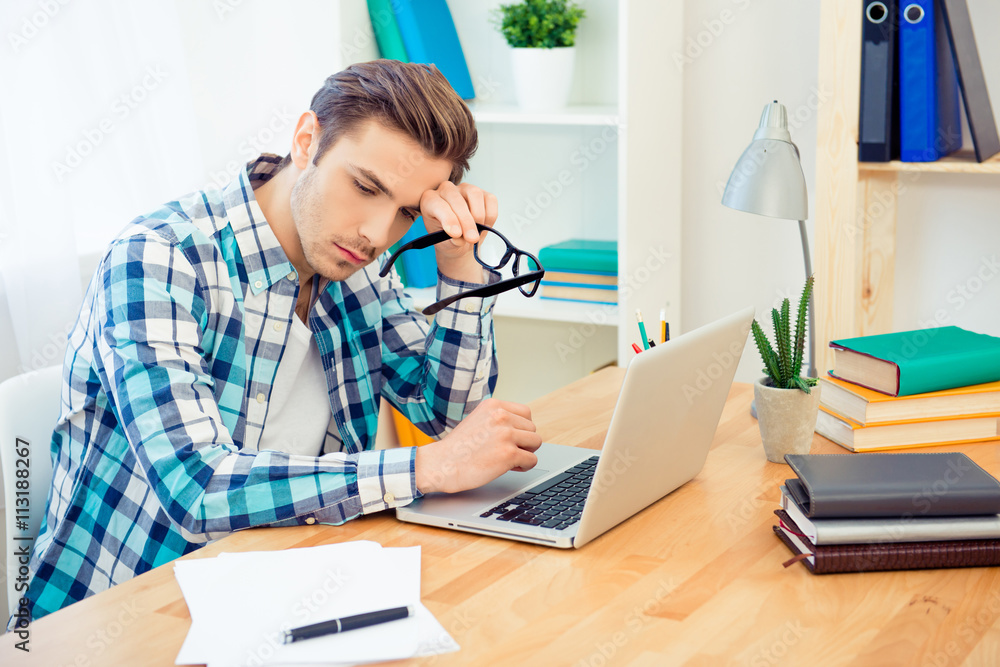 Tired young man having problems with writing new book Tired young man having problems with writing new book