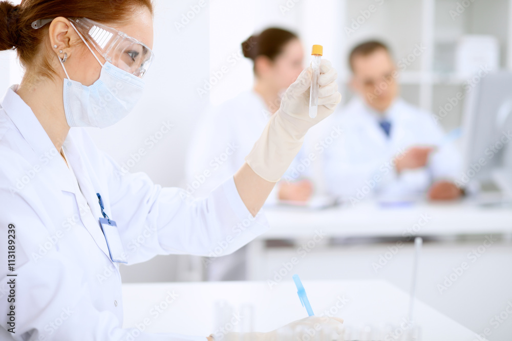 Scientific research team with clear solution in laboratory Scientific research team with clear solution in laboratory